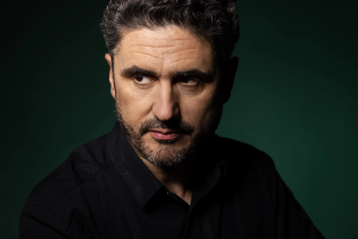 image of man on a dark green gradient